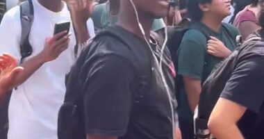 A Texas State University student (front, in black t-shirt) has been met with calls for his expulsion after he repeatedly reenacted Charlie Kirk's assassination at an on-campus memorial held in the conservative activist's honor