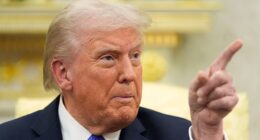 President Donald Trump points as he answers questions from reporters at the White House