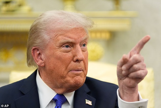 President Donald Trump points as he answers questions from reporters at the White House