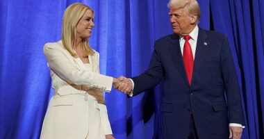 U.S. President Donald Trump and U.S. Attorney General Pam Bondi shake hands during his visit to the Department of Justice to address its workers, in Washington, D.C., U.S., March 14