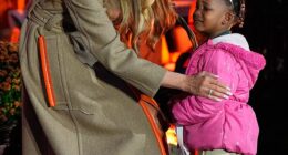 Melania Trump, 55, showed off her maternal side while handing out candy, comforting a young girl who looked frightened at the Halloween decor surrounding her