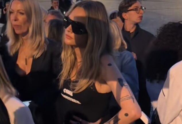 Cara Delevingne looked less than impressed as she was forced to wait in line before entering the Stella McCartney show during Paris Fashion Week on Tuesday