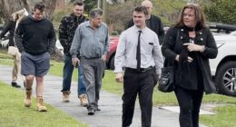 Tyson Michael Delbridge (second from right)  was all smiles as he entered the courthouse on Thursday with his parents and supporters