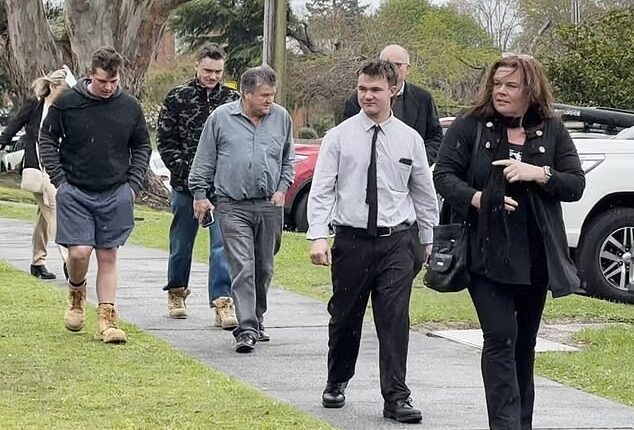 Tyson Michael Delbridge (second from right)  was all smiles as he entered the courthouse on Thursday with his parents and supporters