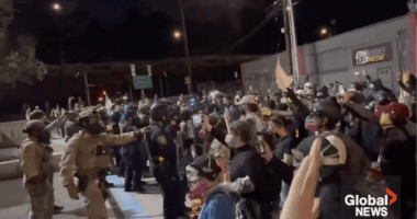 Antifa protesters push against police during a demonstration in Portland.