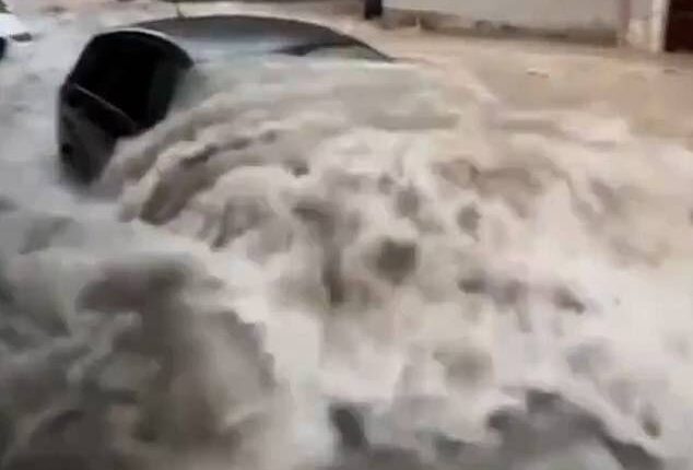 Cars floated down village streets and water engulfed vehicles