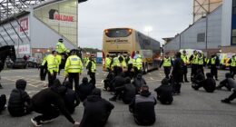 Rangers fans block the team bus with a sitdown protest after their team's 1-1 draw at Falkirk