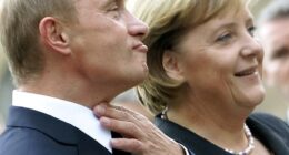 German Chancellor Angela Merkel (R) stands with Russian President Vladimir Putin prior to the two-day 'German-Russian Petersburg Dialogue' conference in the city of Dresden October 10, 2006