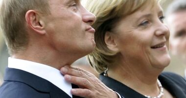 German Chancellor Angela Merkel (R) stands with Russian President Vladimir Putin prior to the two-day 'German-Russian Petersburg Dialogue' conference in the city of Dresden October 10, 2006