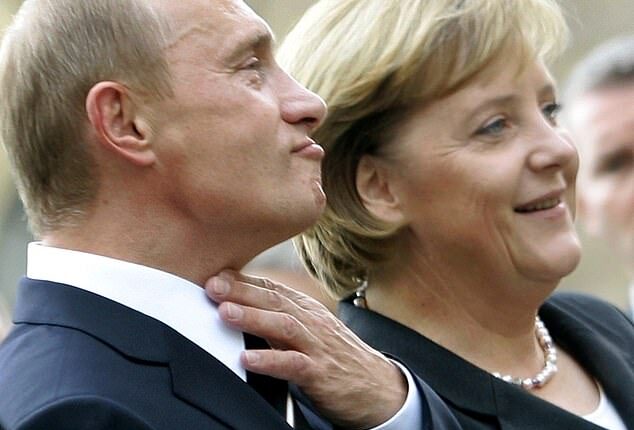 German Chancellor Angela Merkel (R) stands with Russian President Vladimir Putin prior to the two-day 'German-Russian Petersburg Dialogue' conference in the city of Dresden October 10, 2006