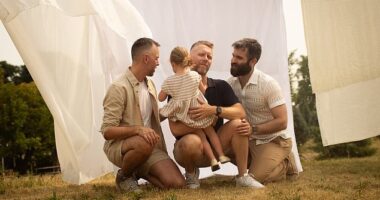 A gay 'throuple' who have adopted a three-year-old girl have launched a lawsuit demanding that their home state of Quebec legally recognizes them as parents