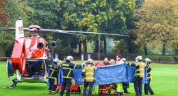 Emergency services stand next to a rescue helicopter in Herdecke, Germany, Tuesday, Oct. 7, 2025, after the newly elected mayor of Herdecke, Iris Stalzer, has been found critically injured in her apartment