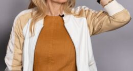 Gillian Anderson showed a glimpse of her cheeky side as she got measured up for her first-ever Madame Tussauds wax figure in London on Thursday