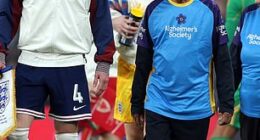 England and Wales players walked out with mascots with dementia ahead of their match at Wembley on Thursday