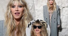 Heidi Klum wears totally see-through lace dress with platinum grill at Vetements during Paris Fashion Week