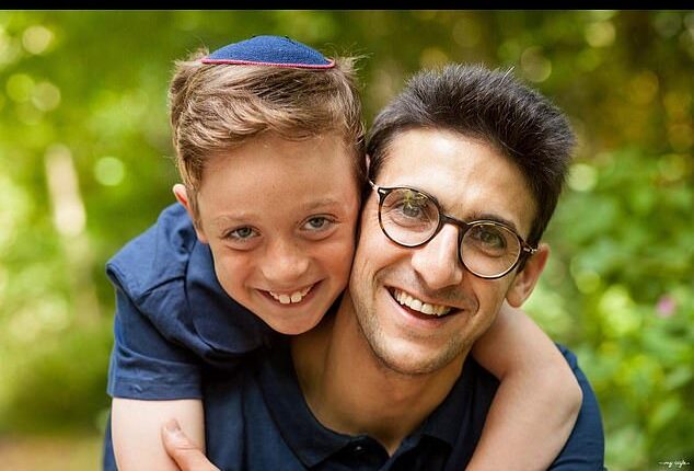 Yoni Finlay (right) saved lives by helping to barricade the door of Heaton Park Hebrew Congregation Synagogue during Thursday's terrorist attack, his son Uriel (now 15) said