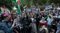 Protestors are pictured after descending on Parliament Square, London, hours after two people were killed in a 'barbaric' knife attack outside the Heaton Park Synagogue in Manchester