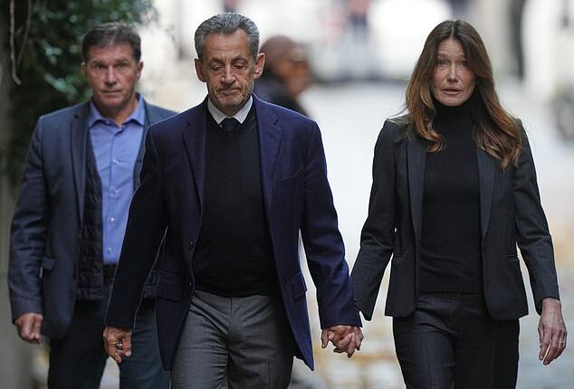 Former French President Nicolas Sarkozy and his wife Carla Bruni-Sarkozy leave their Paris home on Tuesday as Nicolas Sarkozy heads to prison to serve time for a criminal conspiracy to finance his 2007 election campaign with funds from Libya
