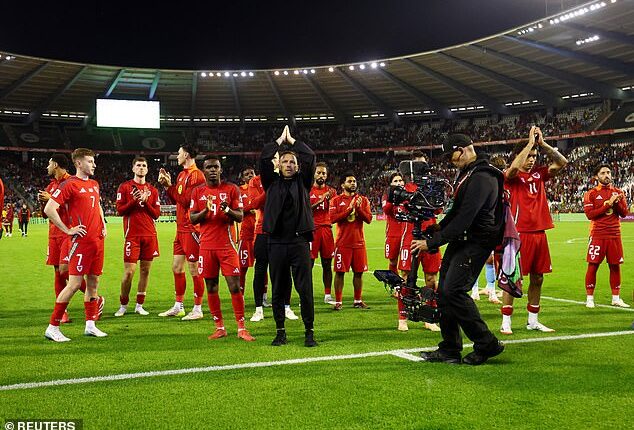 Craig Bellamy (centre) is off to a strong start with Wales, winning six and losing only two of his first 12 matches in charge