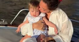 Campbell 'Pookie' Puckett with her 10-month-old daughter Paloma, nestled in Puckett's lap, sitting near the edge of the rocking boat