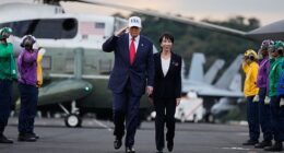 President Donald Trump and Japanese Prime Minister Sanae Takaichi walk on the USS George Washington, an aircraft carrier docked at a U.S. naval base, before speaking to members of the military, in Yokosuka, Tokyo