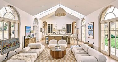 The new open-plan kitchen extension features orangery-style arched windows. A secret pantry area is concealed behind the kitchen and houses the couple’s fridge freezer and dishwasher, as well as further storage. The sofas are from B&B Italia.