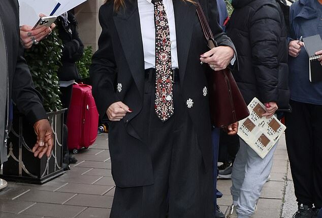 Julia Roberts was ever the accommodating superstar as she stopped for pictures and chatted to fans while leaving Claridges Hotel in London, on Friday