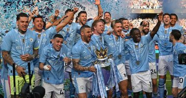 Kyle Walker gets his hands on the Premier League trophy during City's historic Treble season