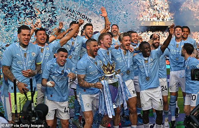 Kyle Walker gets his hands on the Premier League trophy during City's historic Treble season