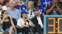 Prince Harry and Meghan Markle were sat in front of Sandy Koufax (L) and Magic Johnson (R)