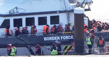 Migrants arrive aboard a Border Force vessel at Dover on Wednesday, when a total of 1,075 arrived across the Channel by small boat