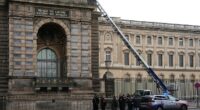 The world-famous Louvre museum in Paris has closed after a gang stole jewellery worth millions (pictured: French police officers next to a ladder propped up against the tourist site)