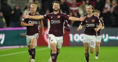 Craig Halkett races off, arms outstretched, after helping his side claim all three points