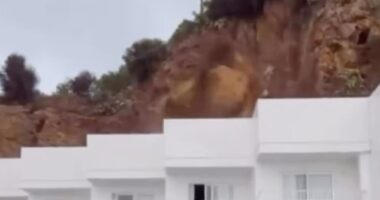 Moment rocks come crashing down on Ibiza hotel in front of screaming British tourists, injuring three people and trapping others as party island is hit by intense storm