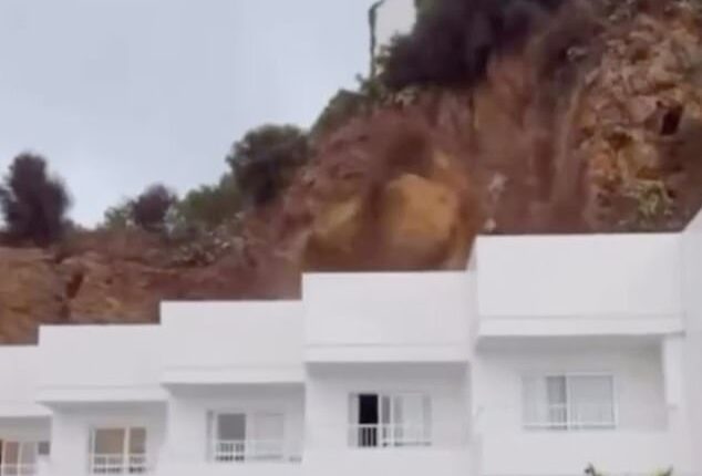 Moment rocks come crashing down on Ibiza hotel in front of screaming British tourists, injuring three people and trapping others as party island is hit by intense storm