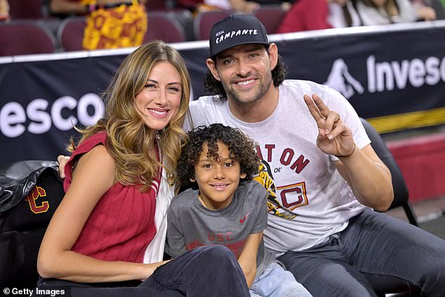 Former USC Trojans and NFL quarterback Mark Sanchez, right, with his wife Perry and son Daniel attend the game against the UCLA Bruins at Galen Center on January 27, 2024