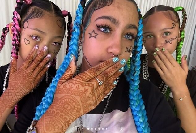 Kim Kardashian's daughter North West has debuted a shocking new look that included fake face tattoos, piercings and grillz