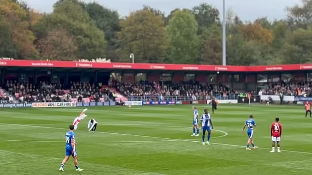 A fan planted a St George's flag in the centre circle during Salford's clash against Oldham in a protest against Gary Neville