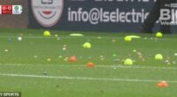 Raging Celtic fans hurl tennis balls and oranges onto the pitch as they delay start of game at Dundee with furious protest against the board