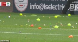 Raging Celtic fans hurl tennis balls and oranges onto the pitch as they delay start of game at Dundee with furious protest against the board