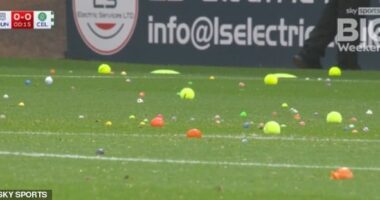 Raging Celtic fans hurl tennis balls and oranges onto the pitch as they delay start of game at Dundee with furious protest against the board
