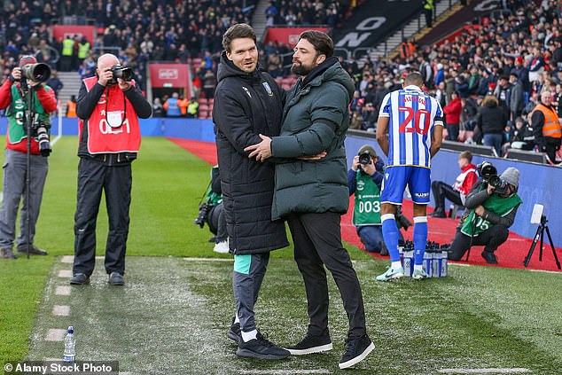 Danny Rohl and Russell Martin embrace each other after a match in the English Championship