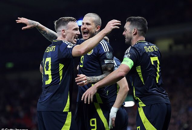 Lyndon Dykes, centre, celebrates with Ferguson and McGinn after scoring the third goal