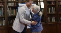 The Duke of Sussex hugs Dr Jane Goodall as he attends her Roots & Shoots Global Leadership Meeting at Windsor Castle in 2019