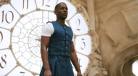 Ncuti Gatwa in a blue and white outfit standing in front of a clock in Doctor Who