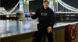 Israel Contreras poses in front of London's Tower Bridge