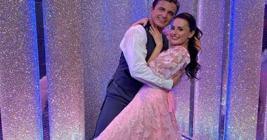 Strictly professional Nikita Kuzmin and his celebrity partner Amber Davies have 'sizzling chemistry' after he was spotted kissing her head in the street