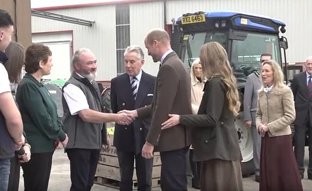 The Princess of Wales appeared slightly anxious as she pulled at her husband's elbow, but in a sweet, surreptitious move, William gestured for her to move to the right (the Wales are seen while visiting Long Meadow Cider in County Armagh on Tuesday)