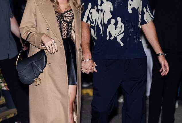 Taylor Swift released her raunchiest song yet with her track Wood from her new album The Life of a Showgirl; pictured with fiancé Travis Kelce in October 2024