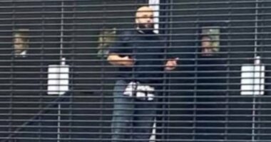 Hero worshippers can be seen in the windows behind Jihad Al-Shamie as they barricaded the doors at Heaton Park Synagogue before police opened fire
